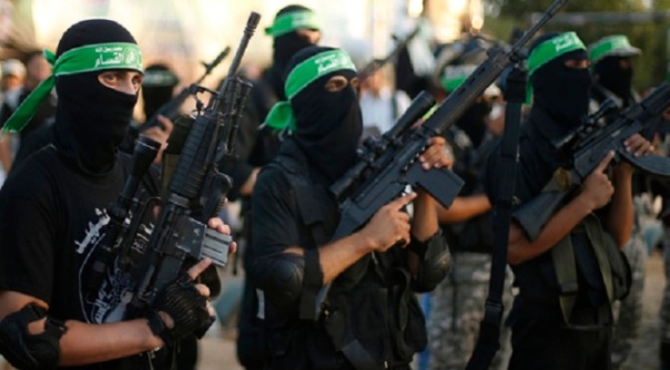 Hamas militants march during a rally in memory of people who were killed during a seven-week Israeli offensive, in Gaza City