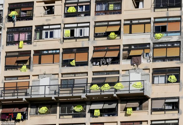 7133354-6470897-Yellow_vests_are_hung_outside_windows_of_an_apartment_building_i-a-17_1544186347947